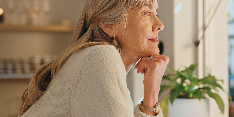 Woman looking hopefully out of window