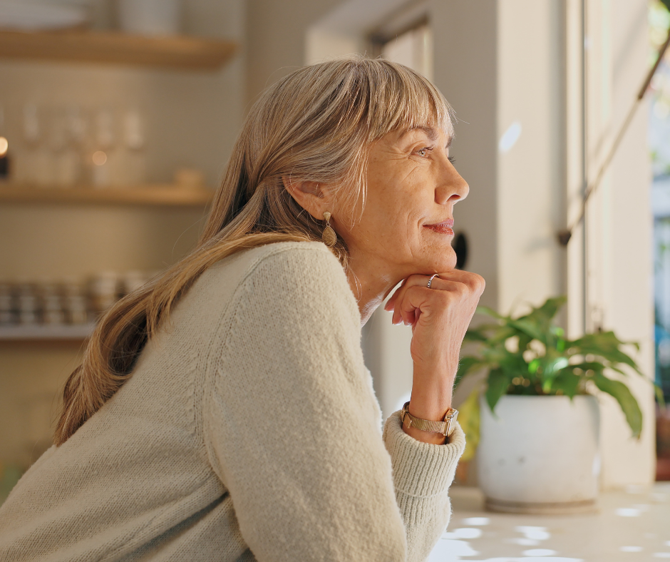 Woman looking hopefully out of window