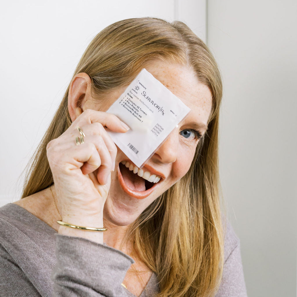 Woman holding a WellSurvivor Breast pack up to her face with a surprised expression.